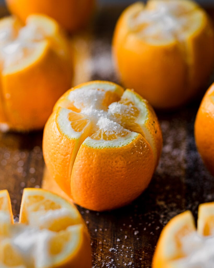 salted lemons on cutting board before being added to a jar to preserve.