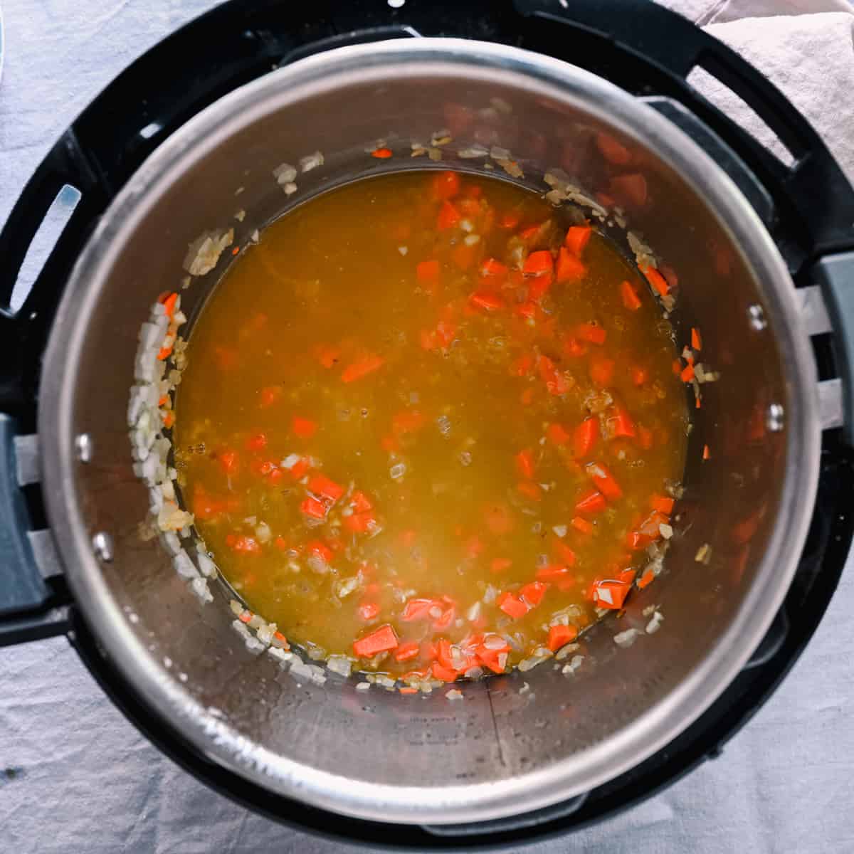 vegetable broth and carrots in instant pot for soup