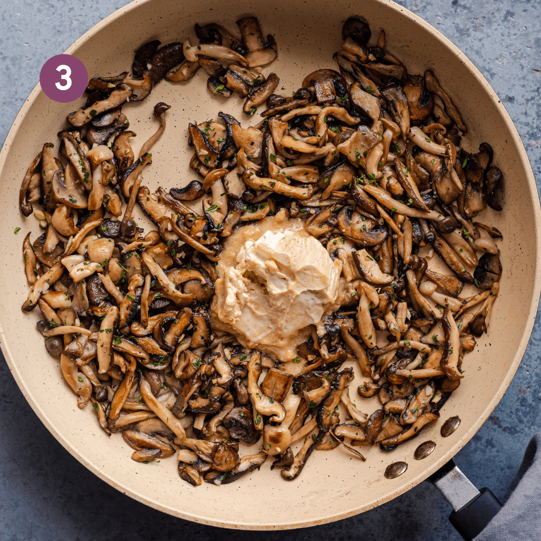 golden brown sauteed mushrooms and garlic in a pan with miso butter on top.