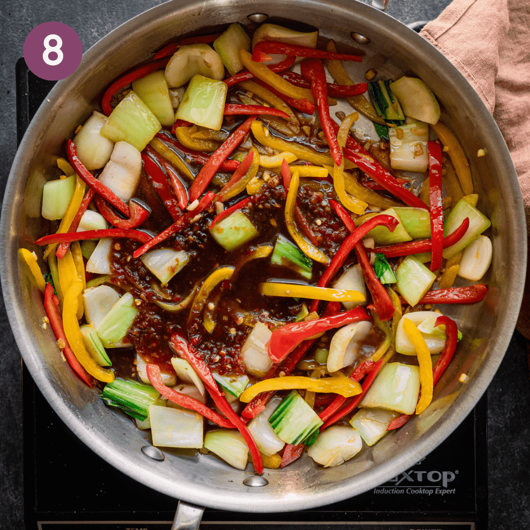 Sauce added to cooked aromatic and vegetable mixture in pan.