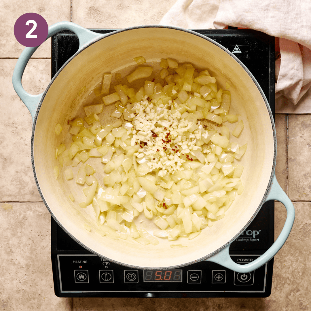 Garlic and pepper flakes added to the sauteed onion.