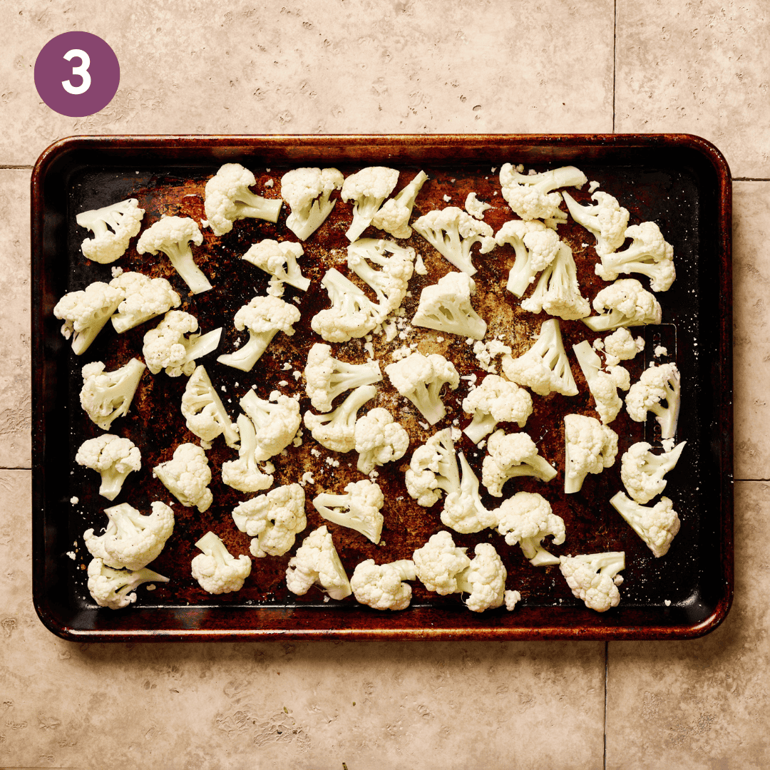 Chopped cauliflower on a baking sheet.