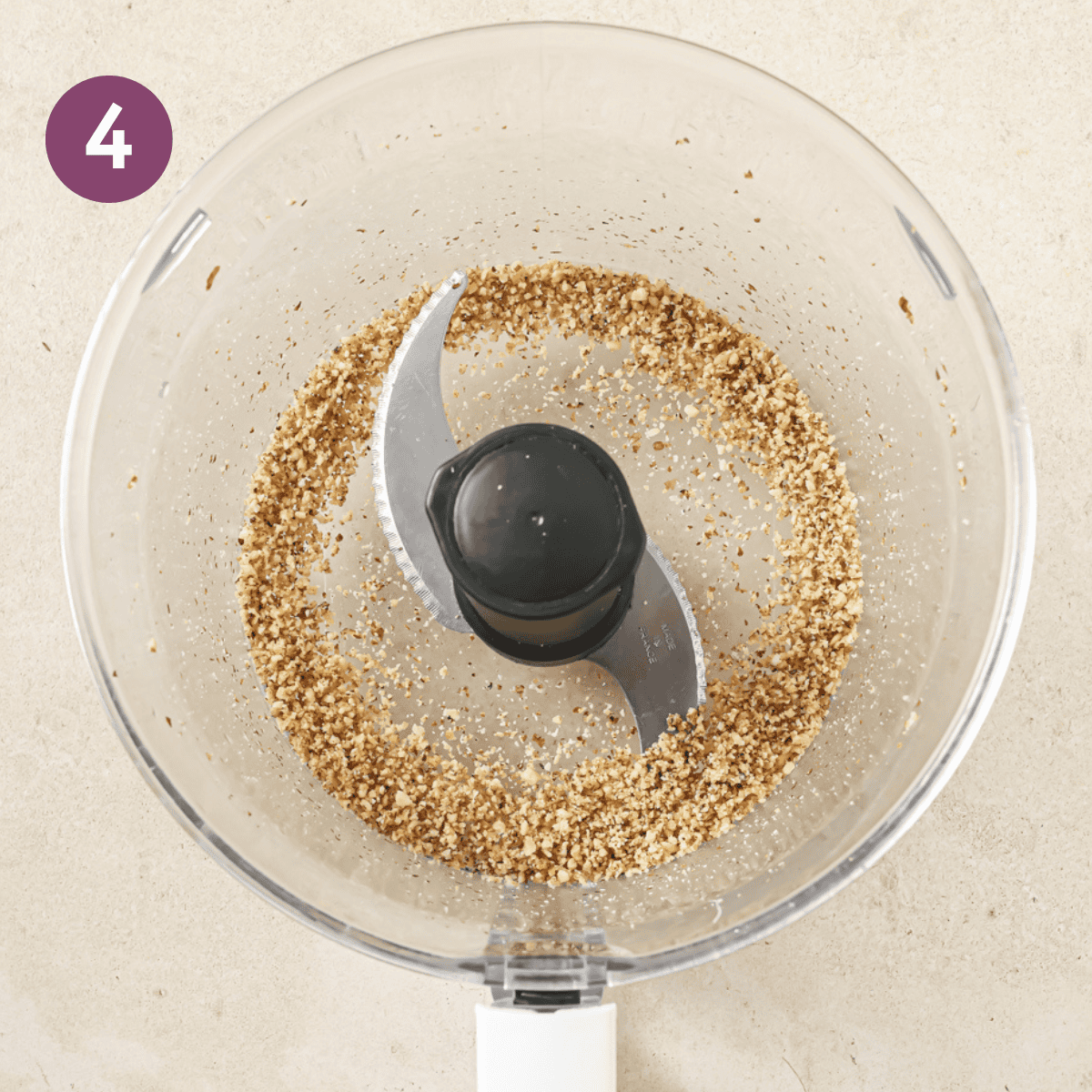 blended walnuts in a white food processor.