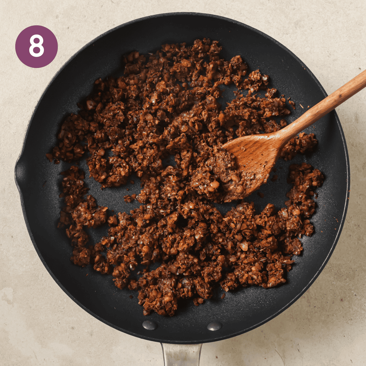 cooked lentil taco filling in a black frying pan.