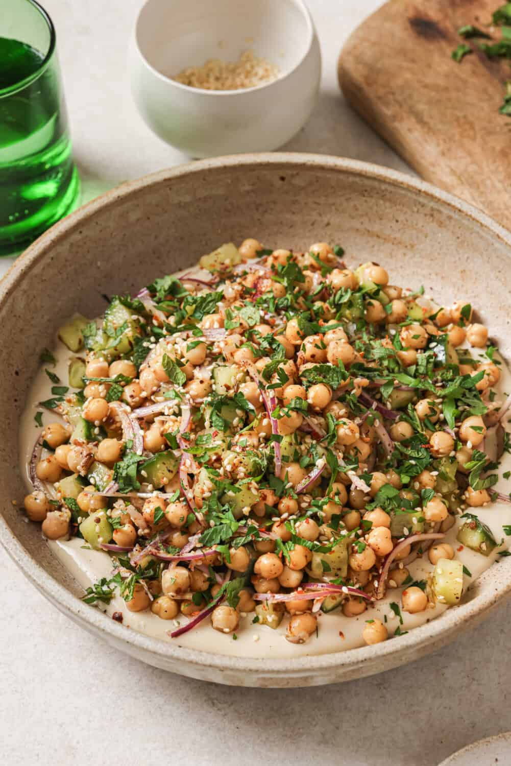 Angled front view of chickpea salad in a bowl.