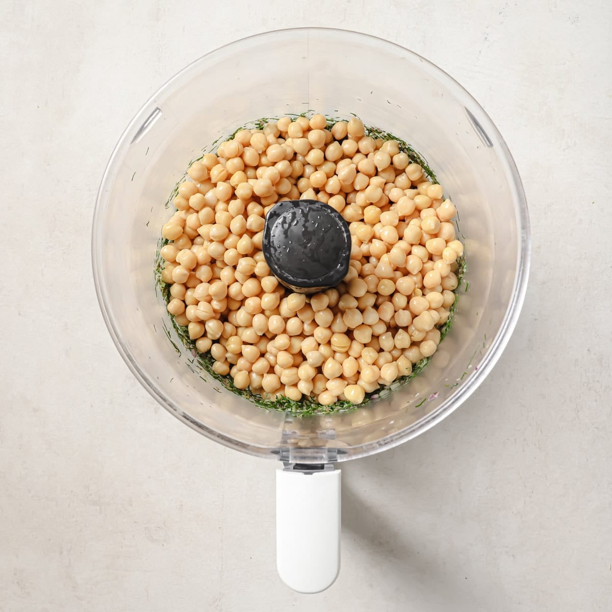 chickpeas added to onion, celery, dill, and capers mixture before being pulsed.