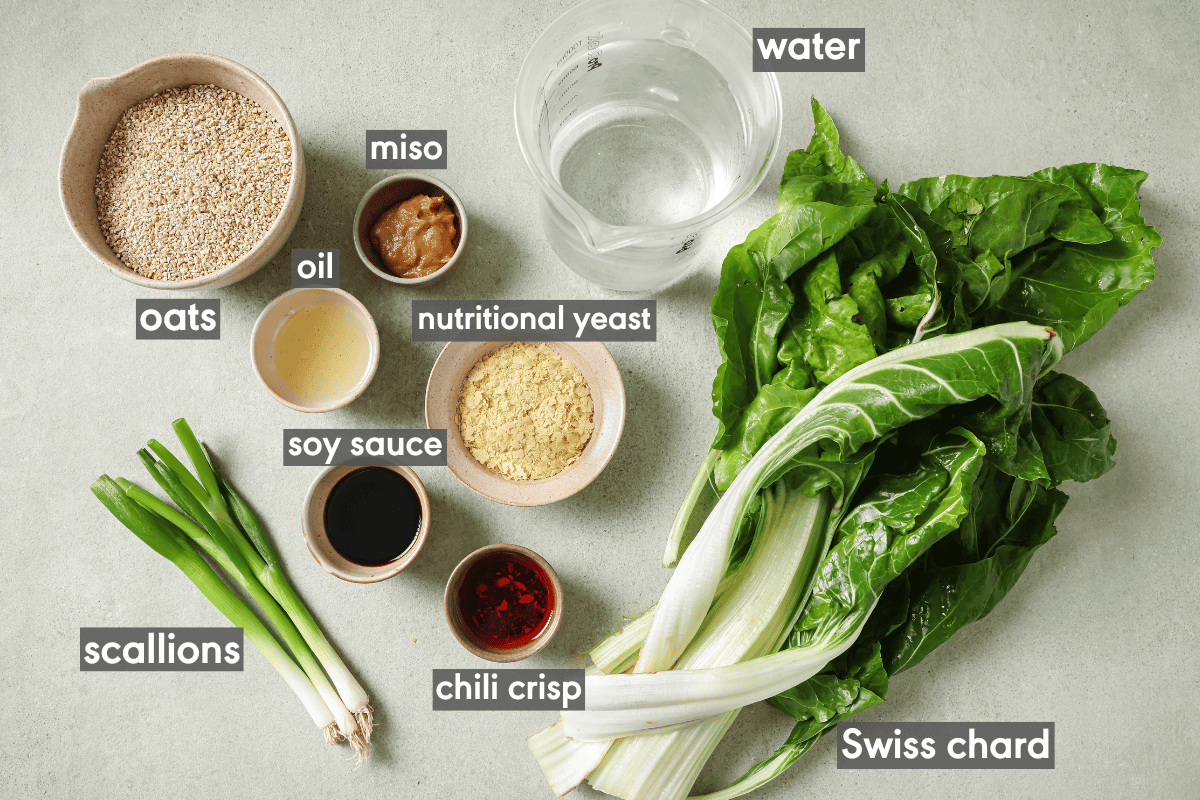 ingredients for savory oats in various bowls on a table.