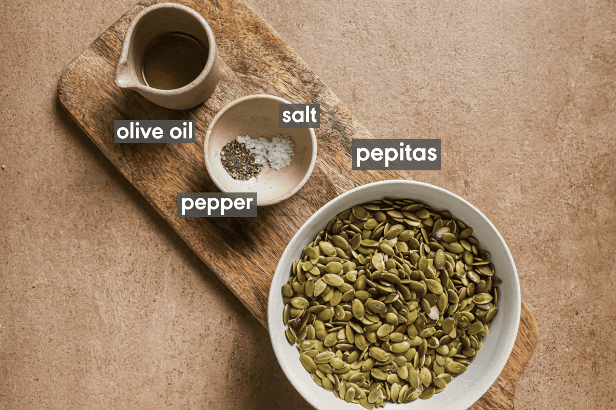 roasted pepitas ingredients in bowls on a wooden cutting board.