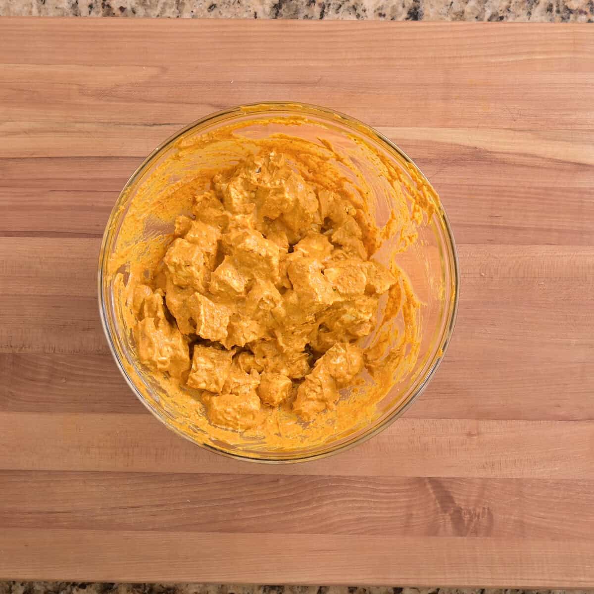 tofu chunks marinaded within bowl.