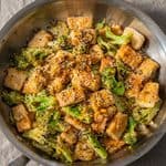 tofu and broccoli stir fry in frying pan.